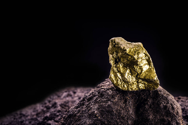 gold nugget on stone, gold inside cave, concept of rarity and luxury - Photo, image