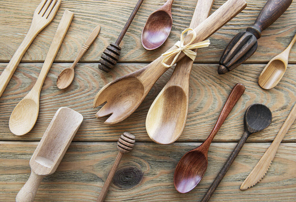 Top view on a wooden cutlery kitchen  ware on a  old wooden background, flat lay - Photo, Image