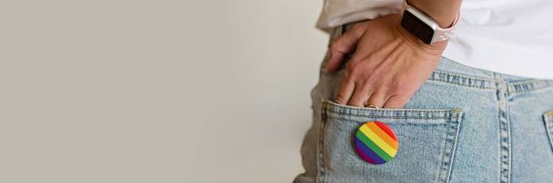 Stylish Woman in blue jeans with the LGBT pride flag sign. Concept of the Pride day, Valentine day, freedom, love. Flat lay, top view, template, overhead - 写真・画像