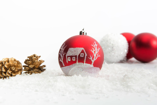 Three Christmas balls in snow on white background - Фото, зображення