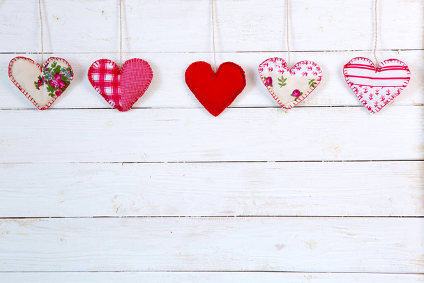 Garland of hearts on a wooden background. Valentine's Day. - Fotografie, Obrázek