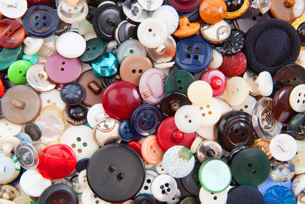 Colored plastic buttons on background, close up - 写真・画像
