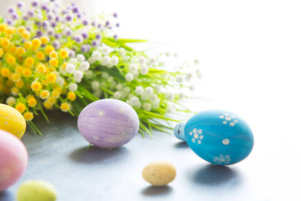 Wildflowers and easter eggs on grey wooden table - Foto, Imagem