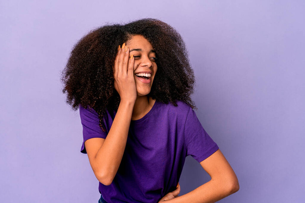 Young african american curly woman isolated on purple background shouting excited to front. - Foto, Bild