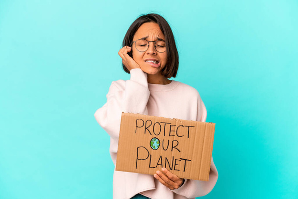 Young hispanic mixed race woman holding a protect our planet cardboard covering ears with hands. - Photo, Image