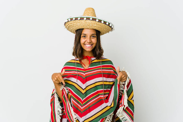 Young mexican woman isolated on white background points down with fingers, positive feeling. - Photo, Image