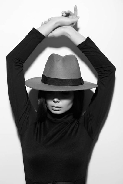 Hermosa joven con sombrero. retrato de moda en blanco y negro de chica morena - Foto, Imagen