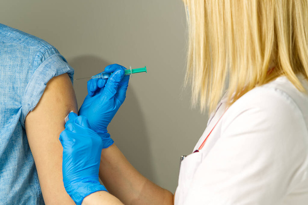 Nurses hands giving an injection in hospital - Photo, Image