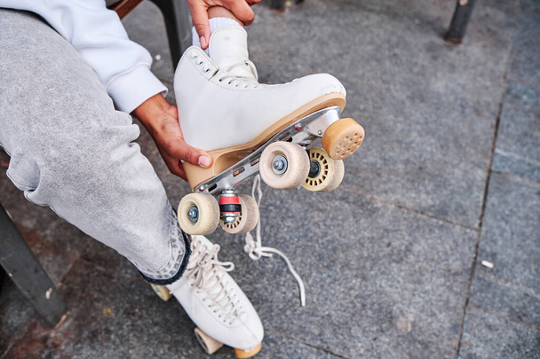 Woman taking off her roller skates. - Photo, Image