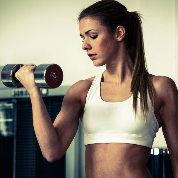 attractive young woman working out with dumbbells - Foto, immagini