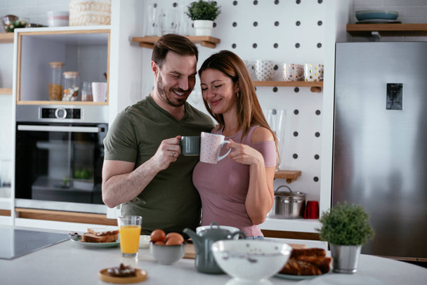 happy couple having breakfast in the kitchen  - Photo, Image