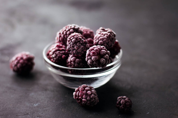Close up of frozen blackberries on a dark background Healthy food vitamins snack dessert - Foto, Bild