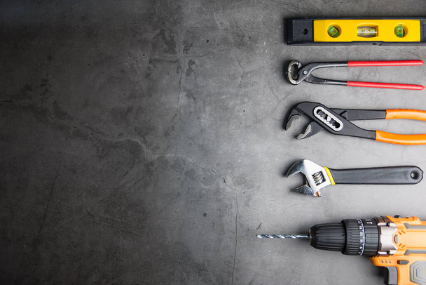 Construction tools on Gray-black cement floor background with copy space.Home Repair concept, Repair maintenance concept, Renovation concept. - Foto, Imagem