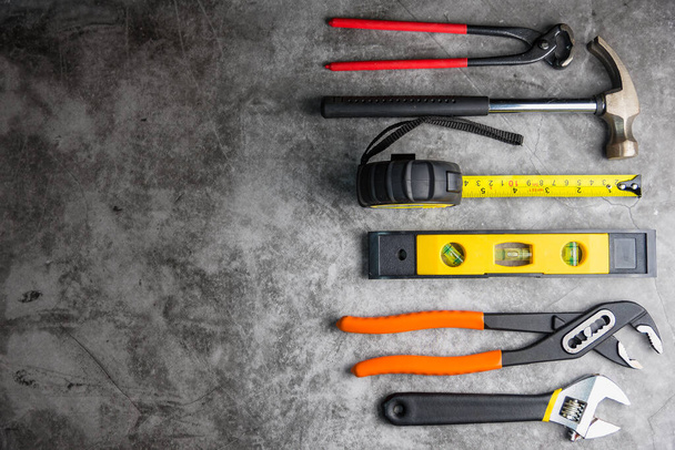 Construction tools on Gray-black cement floor background with copy space.Home Repair concept, Repair maintenance concept, Renovation concept. - Photo, Image