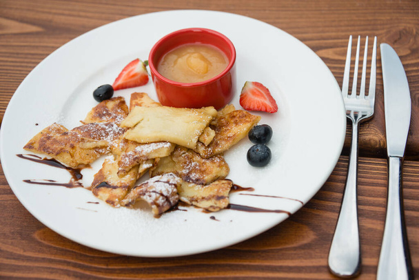 Cut-up sugared pancake with apple puree and forest fruits - Foto, immagini