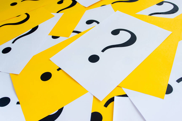 Black question marks on the colored papers, background - Foto, immagini