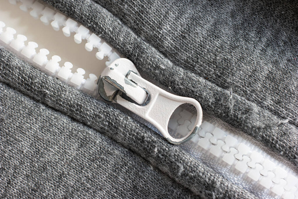 Old metal zipper with peeling white paint macro shot top view. - Photo, Image