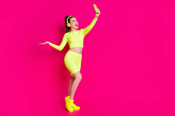 Full length body size view of her she nice attractive slim fit cheerful glad girl listening music taking making selfie free time isolated bright vivid shine vibrant pink fuchsia color background - Fotoğraf, Görsel