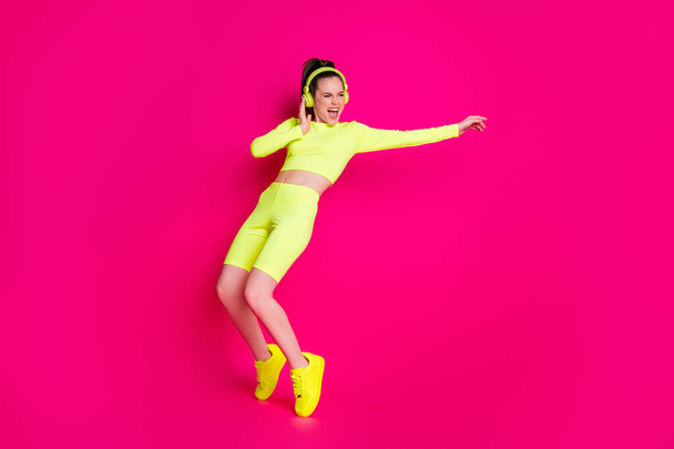 Full length body size view of her she nice attractive slender sporty funky cheerful girl listening music dancing having fun rest chill isolated bright vivid shine vibrant pink fuchsia color background - Fotoğraf, Görsel