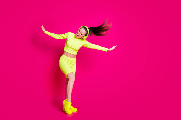 Full length body size view of her she attractive sporty slim cheerful dreamy girl listening pop music having fun enjoying weekend isolated bright vivid shine vibrant pink fuchsia color background - Фото, зображення