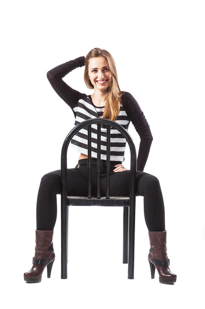 Relaxed woman sitting on a chair is smiling - Foto, Imagen