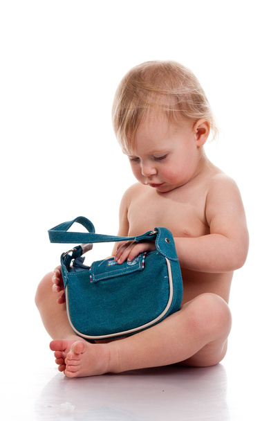 Baby looking into a small bag - Фото, зображення