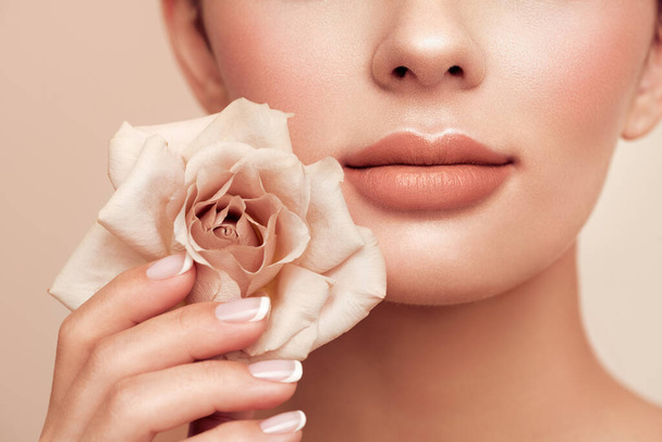 Beautiful model with a rose. Perfect woman face makeup close up. Lipstick. Beautiful nails - Fotoğraf, Görsel