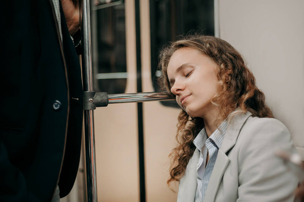 attractive young woman sleeping in a subway car . - Фото, изображение