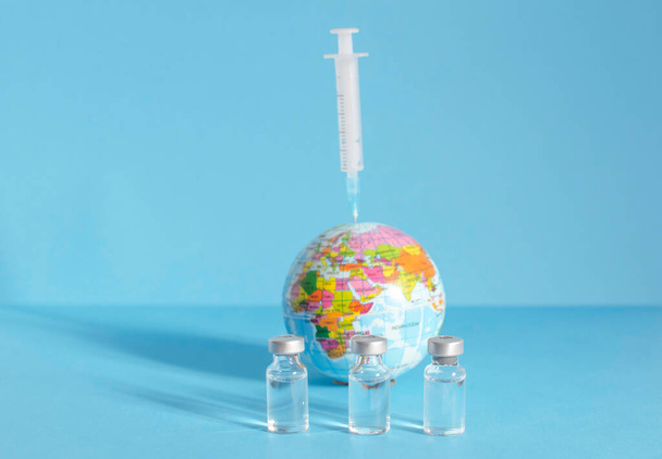 Conceptuele foto voor wereldwijde pandemische vaccinatie, begin van massale vaccinatie voor coronavirus COVID-19, griep of griep, wereldvaccinatie. Selectieve focus - Foto, afbeelding