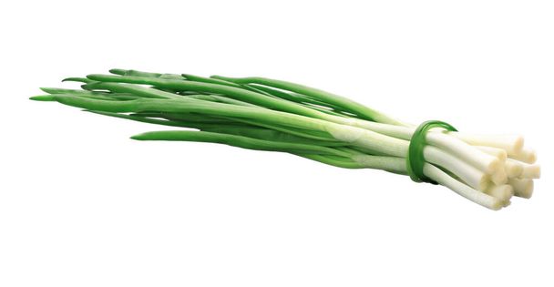green fresh onion feathers are gathered in a bunch on a white isolated background - Photo, Image