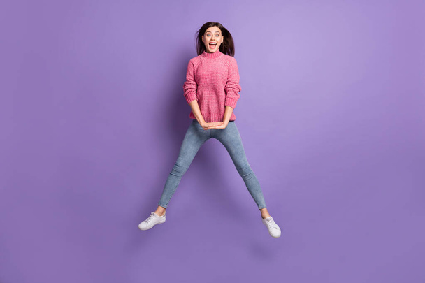 Full length body size photo of jumping girl careless childish laughing isolated on bright violet color background - Foto, Imagem