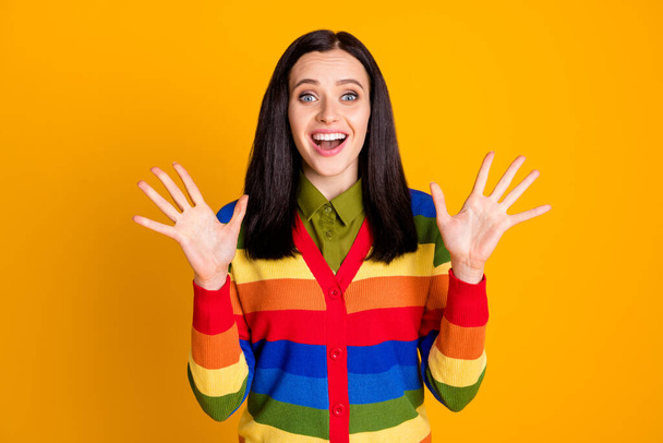 Photo of cheerful young lady surprised shocked smile raise hands palms up isolated over yellow color background - Foto, imagen