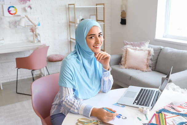 Female Muslim fashion designer working in studio - Photo, Image