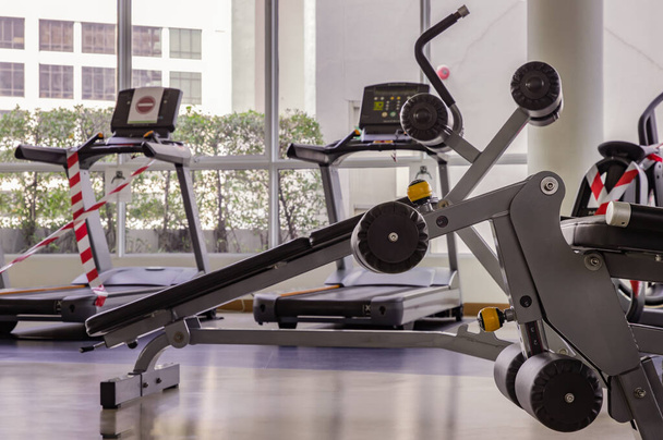 Within gym or fitness studio with modern fitness equipment for fitness events and more. Modern of gym interior with equipment. Sports equipment in the gym. Selective focus. - Foto, Imagem