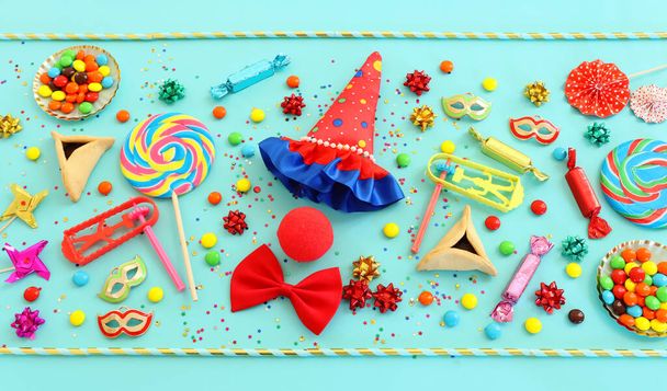 Purim celebration concept (jewish carnival holiday) over blue background. Top view, flat lay - Фото, изображение