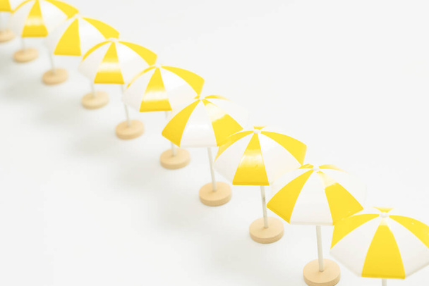 Yellow umbrellas on a white background. Copy space.  - Foto, Bild