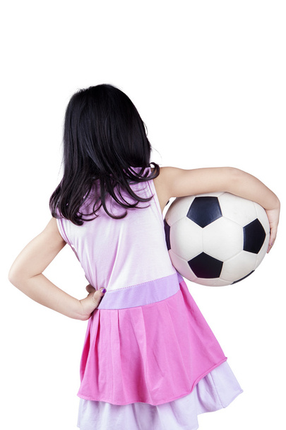 Back view of little girl holding a ball - 写真・画像