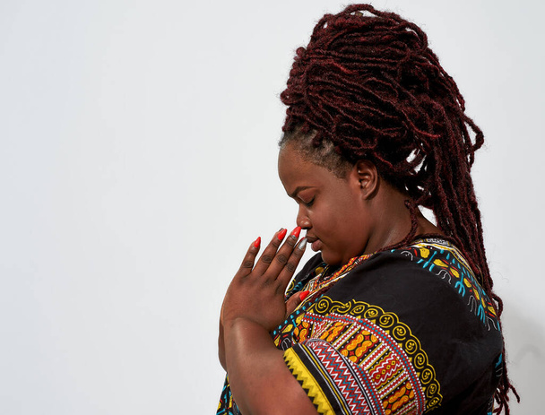 Plump young woman holding hands in prayer - Fotografie, Obrázek