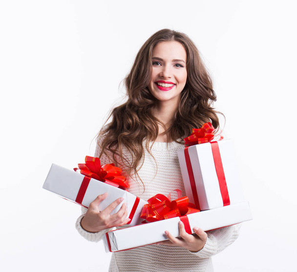 Beautiful smiling woman with a gifts in her hands, studio shot.  - Photo, Image