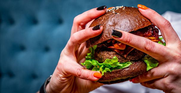 woman hands holding fresh delicious burger - Фото, изображение