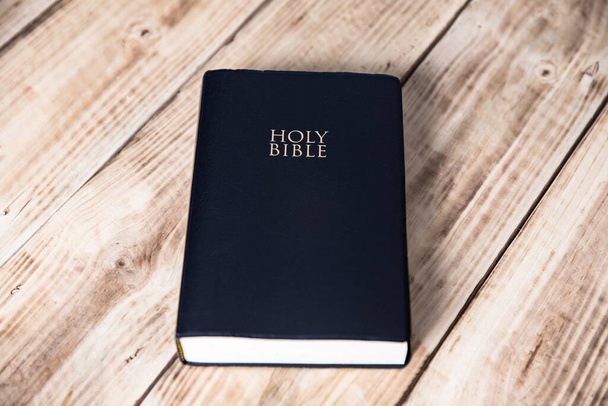 Holy Bible on the wooden table backgroun - Fotó, kép