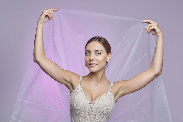 portrait of a beautiful female ballerina. in the studio on a pink background - Foto, Imagem
