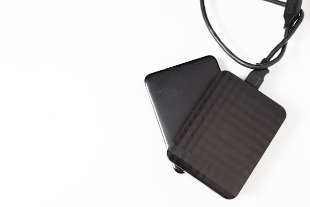 External hard drive or hard disk with USB cable on white background. - Photo, Image
