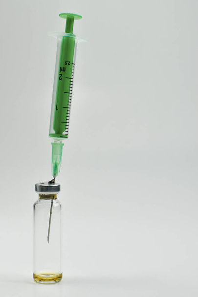 Vials of vaccine and a syringe. Copy the space. - Фото, зображення