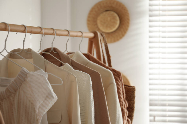 Rack with stylish women's clothes indoors. Modern interior design - Foto, imagen