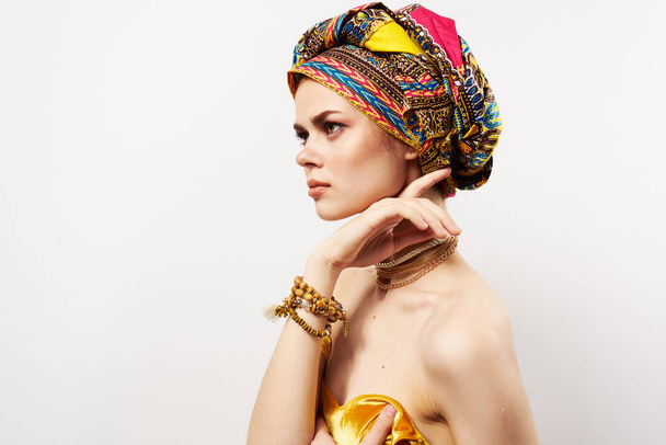 όμορφη ανατολίτικη γυναίκα πολύχρωμο τουρμπάνι κοσμήματα γυμνοί ώμοι πολυτέλεια - Φωτογραφία, εικόνα