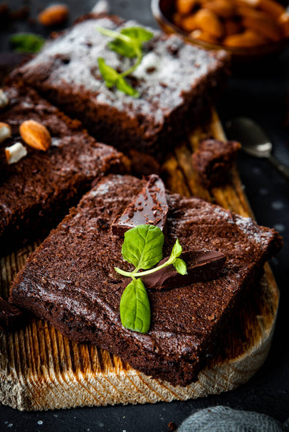  Pieces of homemade chocolate brownie garnished with mint leaves close up vertical photo - Photo, image