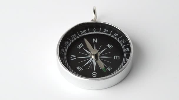Zbliżenie ujęcia wirującego kompasu vintage odizolowanego na białym tle. - Materiał filmowy, wideo