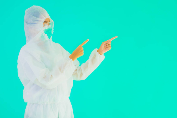 Portrait beautiful young asian doctor woman wear ppe or  personal protective equipment for protect from coronavirus or covid19 on blue isolated background - Foto, afbeelding