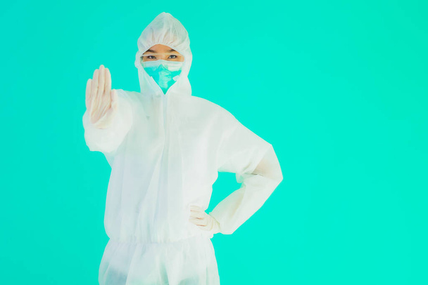 Portrait beautiful young asian doctor woman wear ppe or  personal protective equipment for protect from coronavirus or covid19 on blue isolated background - Photo, Image